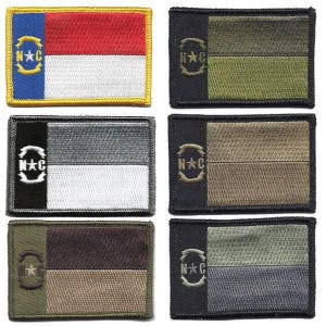 May include: A collection of rectangular embroidered patches. One patch features the North Carolina state flag design. Other patches have a flag design with the letters "N*C" and a star. The patches are in various colors.