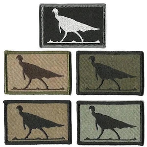 May include: Embroidered patches featuring a turkey silhouette. The patches come in various colors, including black, olive green, and tan. The turkey design is a simple, yet detailed outline, suitable for outdoor enthusiasts or those interested in wildlife.