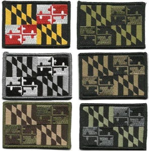 May include: Six embroidered patches featuring the Maryland state flag design. The patches display the flag's distinctive quartered pattern in various color schemes, including black, yellow, red, white, and green. Each patch has a black border.
