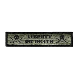 May include: A rectangular olive green embroidered patch with a black border. The text LIBERTY OR DEATH is centered in black block letters. On each side of the text is a black skull and crossbones emblem, featuring a skull above two crossed swords.