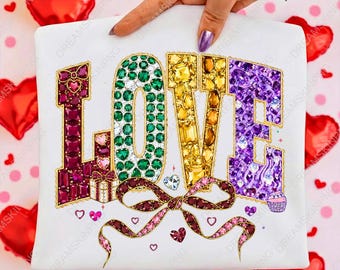 May include: A white t-shirt with the word "LOVE" spelled out in colorful gemstones. The letters are in shades of red, green, yellow, and purple. A large bow and small hearts decorate the bottom of the shirt.
