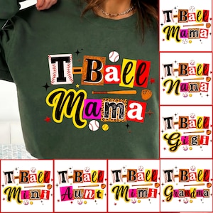 May include: Dark green sweatshirt with a colorful graphic that says "T-Ball Mama" in a bold, playful font. The design includes baseballs, bats, and stars. Additional designs include "Nana", "Gigi", "Mini", "Aunt", "Mimi", and "Grandma".