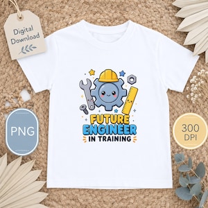 以下が含まれることがあります： 白いTシャツ。歯車、レンチ、ボルト、定規の漫画のグラフィック。テキスト「FUTURE ENGINEER IN TRAINING」が下に印刷されています。「Digital Download」タグが見えます。