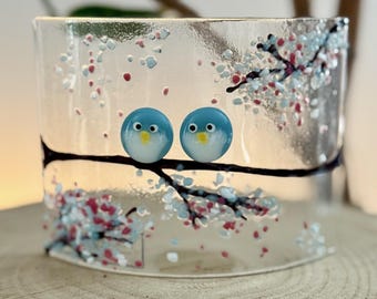 Handmade glass curve featuring blue birds in the blossom.