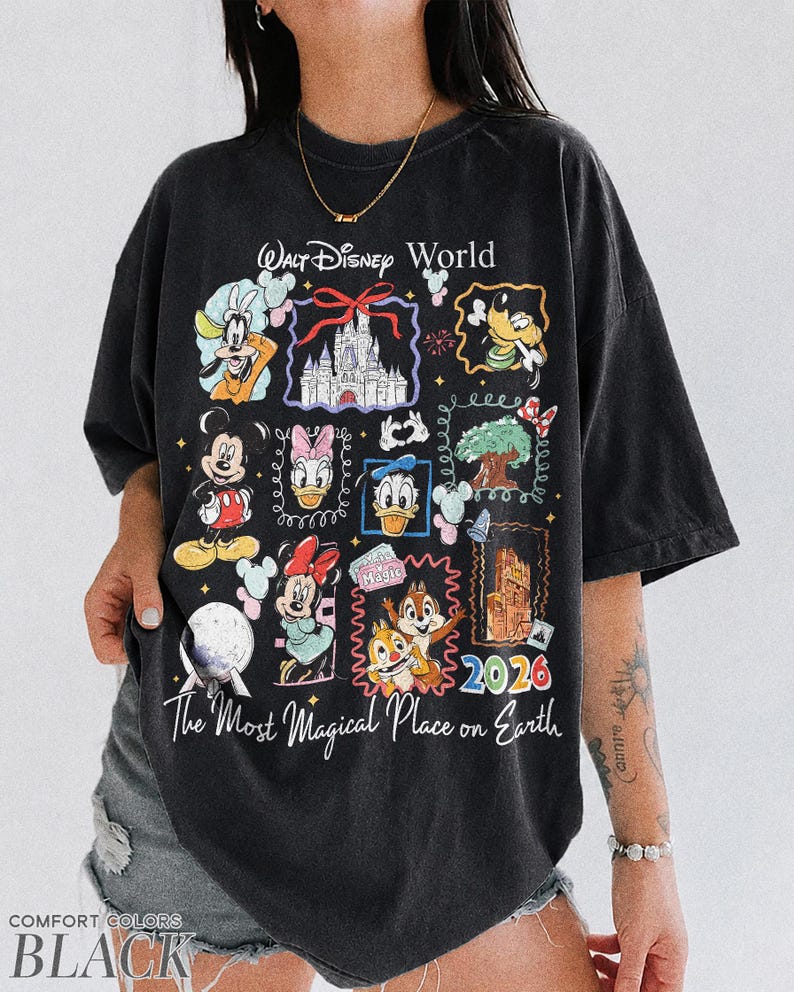 May include: Black t-shirt featuring a colorful graphic of Disney characters and landmarks. The design includes Mickey Mouse, Minnie Mouse, Donald Duck, and Chip and Dale, with the text "Walt Disney World" and "The Most Magical Place on Earth". The year "2026" is also displayed.
