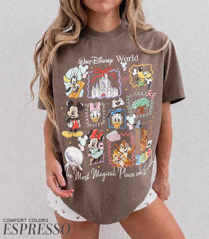 May include: Espresso-colored t-shirt featuring a collage of Disney characters and the text "Walt Disney World" and "The Most Magical Place on Earth." The design includes Mickey Mouse, Minnie Mouse, Donald Duck, and Goofy. The year 2016 is also visible.