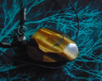 Ladies Tiger Eye pendant with black cord and sterling silver clasp.