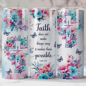 May include: A stainless steel tumbler with a floral design featuring pink, blue, and purple flowers, butterflies, and a cross. The tumbler has the text "Faith does not make things easy it makes them possible" and the Bible verse Luke 1:37.