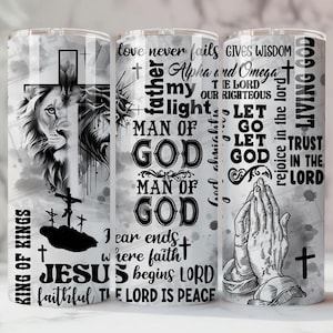 May include: Three stainless steel tumblers with religious themes. One features a lion and cross, another has text including "Man of God", and the third displays praying hands and the words "Living God".