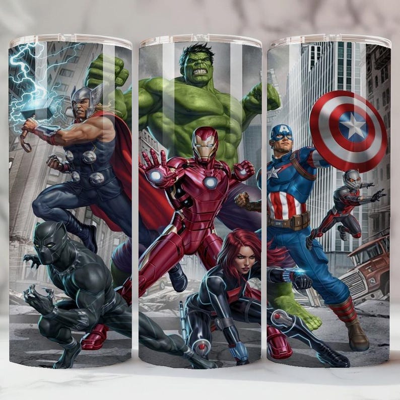 May include: A stainless steel tumbler with a colourful design of Marvel superheroes. The image includes Thor, Hulk, Iron Man, Captain America, Black Panther, Black Widow, and Ant-Man, set against a city background. The tumbler is cylindrical and likely holds approximately 590 ml.