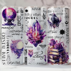 May include: Three white tumblers with mystical designs. One features a crystal ball, another a large purple crystal, and the third a raven and stacked books. Text includes "Crystal Balls", "Magic", "Witchy Vibes", and "Manifest".