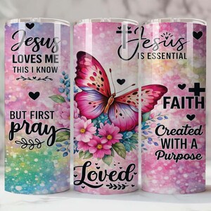 May include: Three stainless steel insulated tumblers with inspirational quotes and floral and butterfly designs. The tumblers feature the phrases "Jesus Loves Me", "But First Pray", "Jesus is Essential", "Faith", and "Created With a Purpose".