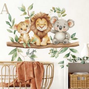 May include: Watercolor illustration of a tiger, lion, and koala bear sitting on a tree branch with green leaves. The animals are smiling. The letter "A" is in the upper left corner. The image is a wall decal.