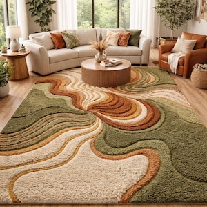 May include: A large, plush area rug with a swirling, abstract design in shades of green, brown, and cream. The rug is the focal point of a living room, complementing the neutral-toned furniture and natural light.