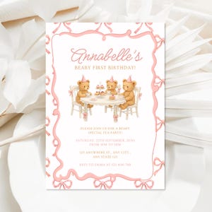 May include: A pink and white invitation with the text "Annabelle's Beary First Birthday!" features three teddy bears at a tea party. The invitation includes event details and is framed with pink bows.