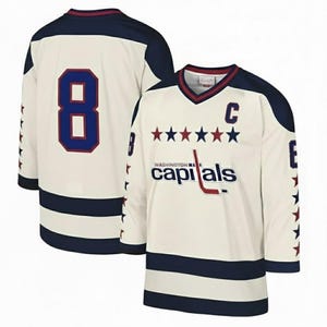 May include: Off-white hockey jersey with navy blue and burgundy accents. Features the number 8 on the back and the word "capitals" with a hockey stick graphic on the front. Includes a "C" for captain and star details.