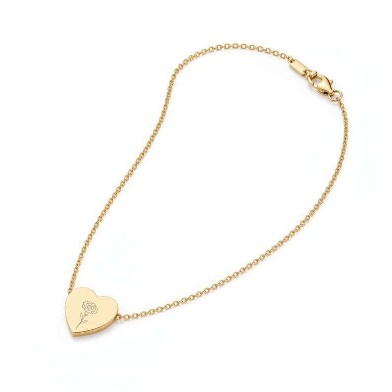 Gold January birth flower heart necklace laid flat, showing the 18-inch cable chain and lobster clasp
