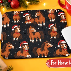 May include: A rectangular mouse pad featuring a repeating pattern of brown horses wearing red Santa hats and red bow ties with small bells, set against a black background with white polka dots resembling falling snow.