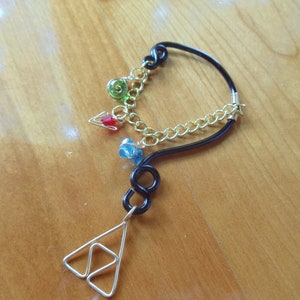 The L.O.Z.® Wise Ear Bend with Hanging Spiritual Stones and Triforce in Black