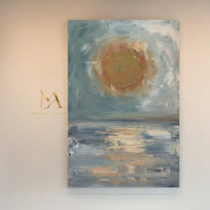 May include: Abstract oil painting of a seascape with a large, textured orange sun in a light blue sky. The water below reflects the sunlight. The painting is displayed on a white wall.