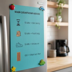 May include: A teal countdown board with the text "MAIN COUNTDOWN BOARD" and a schedule. The board is decorated with a red apple, a blue car, a green dinosaur, and a yellow star magnet. The schedule includes icons and time intervals.