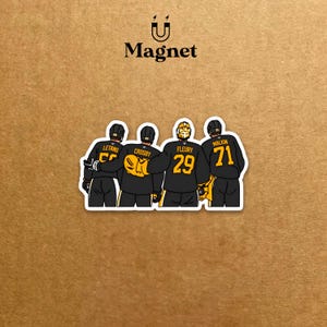 May include: A magnet with a cartoon illustration of four hockey players in black and gold uniforms. The names Letang, Crosby, Fleury, and Malkin are visible. The word "Magnet" is printed above the illustration.