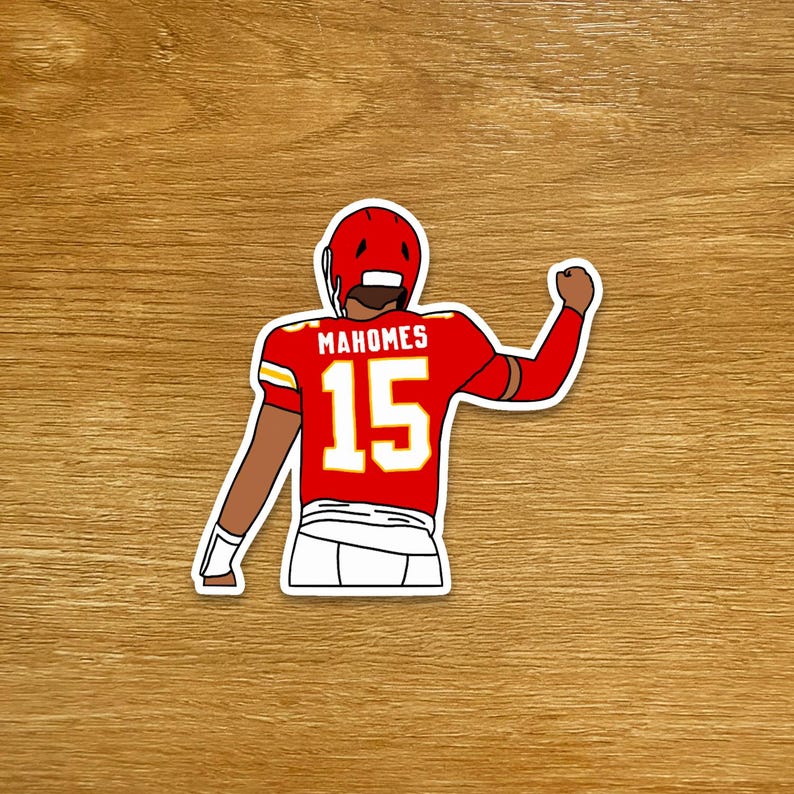 May include: A sticker featuring a cartoon illustration of a football player in a red uniform with the name "Mahomes" and the number "15". The player is wearing a red helmet and white pants, with his fist raised in a celebratory gesture.
