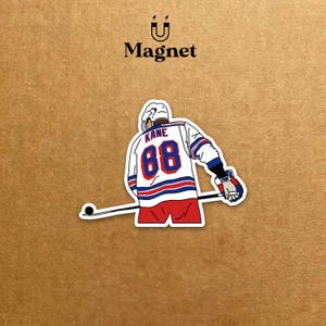 May include: A sticker magnet depicting a hockey player in a white, red, and blue jersey with the number 88 and the name "Kane". The player is holding a hockey stick. The word "Magnet" is above the hockey player.