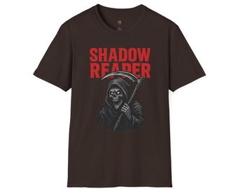 May include: Brown t-shirt featuring a graphic of the Grim Reaper holding a scythe, with the words "SHADOW REAPER" in red block letters above the image. The Reaper is depicted in black and white.