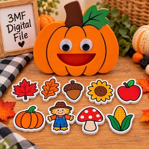 May include: A large orange pumpkin cutout with googly eyes and a wide smile, accompanied by nine smaller autumn-themed cutouts including a red maple leaf, oak leaf, acorn, sunflower, apple, pumpkin, scarecrow, mushroom, and corn cob.