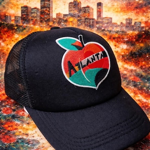 May include: A set of three ceramic mugs with a speckled, matte finish. The mugs are in shades of cream, light gray, and dark gray. Each mug has a simple, minimalist design and a rounded handle.