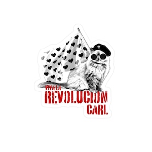 May include: A sticker featuring a cat wearing sunglasses and a beret, holding a flag with heart shapes. The flag is white with black hearts. The text "VIVA LA REVOLUCION CARL" is printed in red.