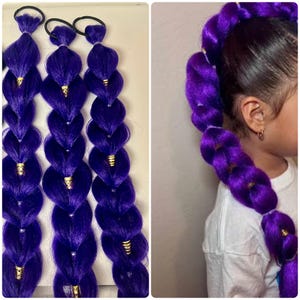 May include: Three purple braided hair extensions with gold accents and black hair ties. The extensions are a vibrant shade of purple and are styled in a series of puffy braids. The image also shows a child with a long purple braided ponytail.
