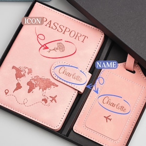 May include: A pink passport holder and luggage tag set. The passport cover features a world map design and the name "Charlotte". The luggage tag also has the name "Charlotte" and an airplane icon. The set is presented in a black gift box.