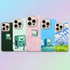 May include: A collection of five phone cases featuring the character BMO from Adventure Time. Each case has a different background color, including green, light green, pink, blue, and a sky-themed design. The BMO character is depicted in various poses.