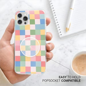 May include: A clear phone case with a colorful checkerboard pattern in pastel shades of pink, yellow, green, and blue. The case is labeled "EASY TO HOLD POPSOCKET COMPATIBLE".