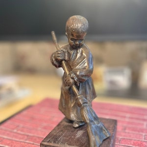 Vintage bronze sweeping child