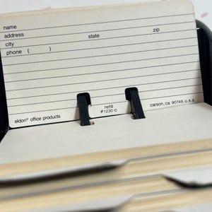 May include: A beige address book refill card with lines for name, address, city, phone, state, and zip code. The card has the text "refill #1230-0" and "eldon office products".
