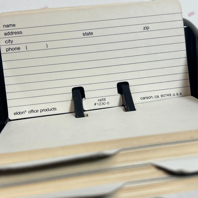 May include: A beige address book refill card with lines for name, address, city, phone, state, and zip code. The card has the text "refill #1230-0" and "eldon office products".