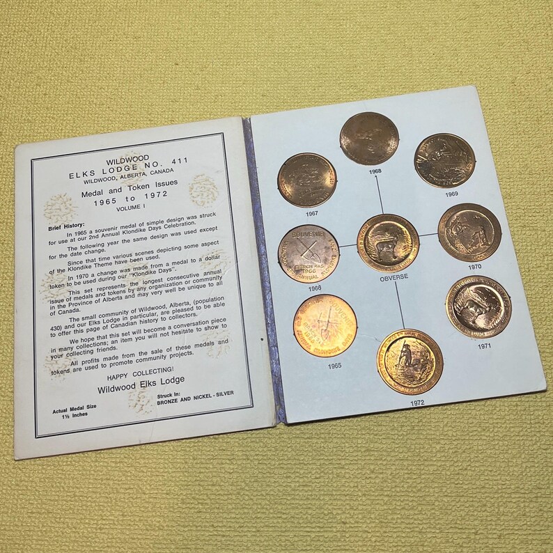 May include: A collection of Wildwood Elks Lodge medals and tokens from 1965 to 1972, displayed in a booklet. The booklet includes text about the medals and their history. The medals are bronze and nickel-silver, each approximately 1.5 inches in diameter.