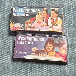 May include: Two vintage Westinghouse Flash Cubes boxes. The boxes feature images of children and the text "Westinghouse Flash Cubes". Each box contains 3 cubes and 12 flashes.