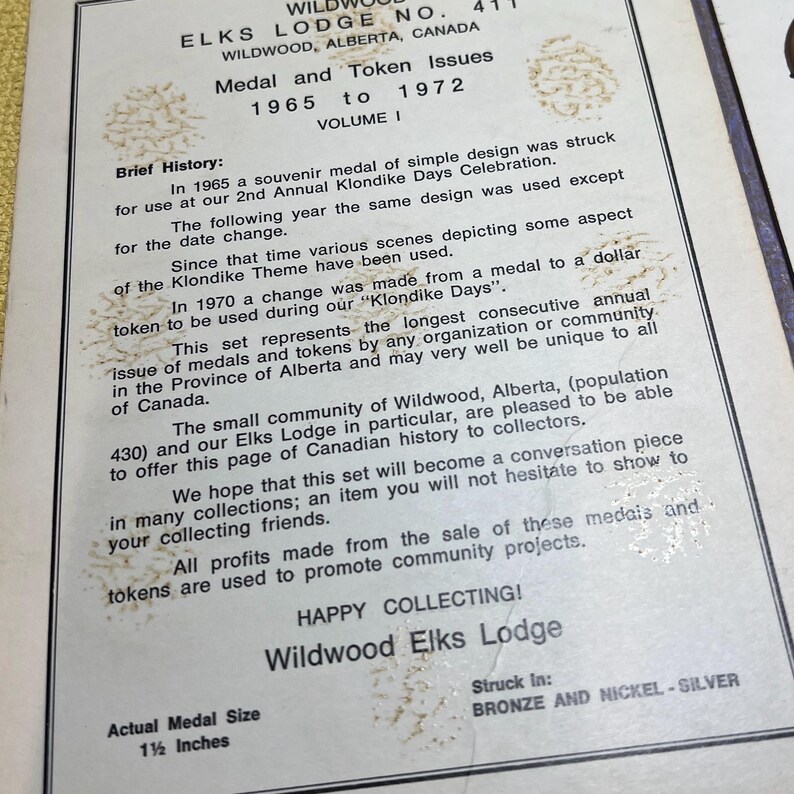 May include: A vintage document from the Wildwood Elks Lodge, Alberta, Canada, detailing medal and token issues from 1965 to 1972. The text includes a brief history, with the actual medal size being 1.5 inches.