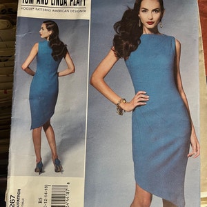 May include: A sewing pattern for a blue dress with a diagonal hemline. The pattern is from Vogue Patterns and designed by Tom and Linda Platt. The pattern number is V1267 and the size is B5 (8-10-12-14-16).