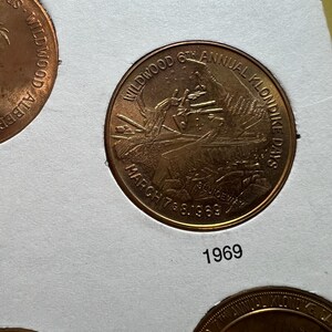 May include: A bronze coin from the Wildwood 6th Annual Klondike Days, dated March 7 & 8, 1969. The coin features an image of a person and text that reads "Wildwood 6th Annual Klondike Days" and "March 7 & 8, 1969". The year "1969" is printed below the coin.