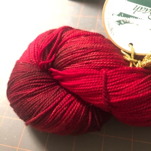 One skein Baah La Jolla Superwash Merino Fingering yarn in Chocolate Cherries