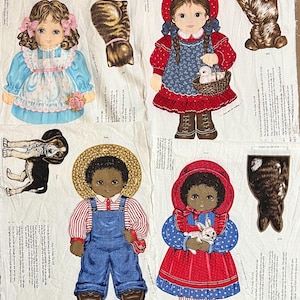May include: Fabric panel featuring cut-out doll designs. Includes a girl in a red hooded dress holding a basket with a chick, a boy in overalls, and a girl in a blue dress. Also includes a dog and cat.
