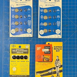 May include: An assortment of vintage sewing notions, including two Shelton Dot Snapper Buttons cards, a Traum Silk Covered Snaps card, and a Dritz Snag-Pruf Zipper Repair Kit card. The cards feature text and illustrations, with prices and product details.