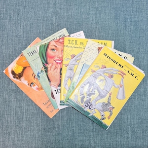 May include: A collection of vintage sports program booklets featuring various college football games. The programs are yellowed with age and have black and white illustrations of players in action. The programs include games between T.C.U. vs. Texas Tech, Missouri vs. S.M.U., and Texas vs. Alamo Stadium.