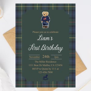 May include: A birthday invitation with a green and blue plaid border. The invitation features a teddy bear wearing a sweater and jeans. Text includes "Liam's First Birthday" and event details.