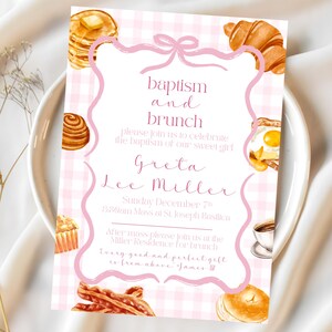 May include: A pink and white gingham baptism and brunch invitation. The invitation features watercolor illustrations of breakfast foods like pancakes, croissants, and bacon. The text reads "baptism and brunch" and invites guests to celebrate Greta Lee Miller's baptism.